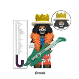 Load image into Gallery viewer, Brook custom brick minifigure from One Piece, with a crown, orange feather collar and green guitar.