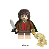 Load image into Gallery viewer, Frodo Baggins custom brick minifigure from The Lord of the Rings, with brown hair, green cloak, small sword and Gollum accessory.