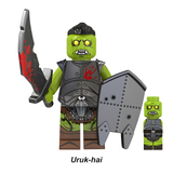 Load image into Gallery viewer, Uruk-hai shield warrior custom brick minifigure from The Lord of the Rings, with green skin, a curved sword and gray shield.